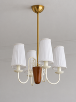 Scroll-arm chandelier with 4 white pleated fabric shades, shown unlit, product view