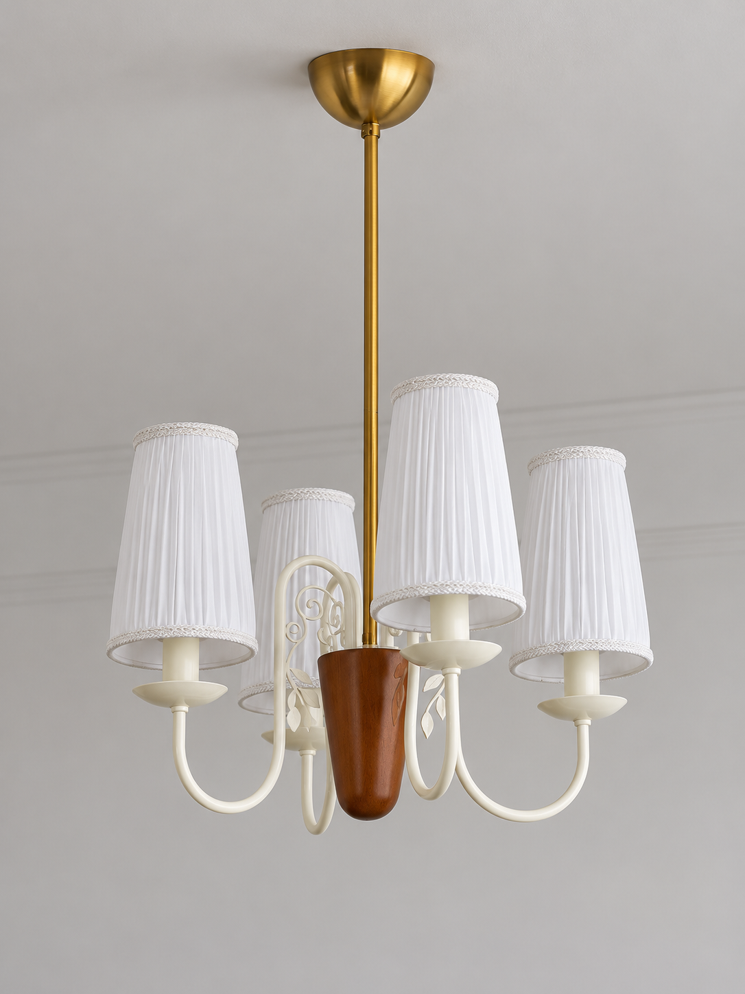 Scroll-arm chandelier with 4 white pleated fabric shades, shown unlit, product view