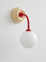 Ivory + Red wall sconce with curved red arm and white glass globe, shown unlit, product view