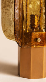 Close view of textured amber glass and copper-tone electroplated iron on Amber Grid table lamp