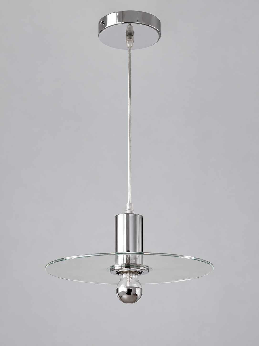 Clear glass disc pendant lamp with half-chrome bulb finish and chrome-tone fittings, shown unlit