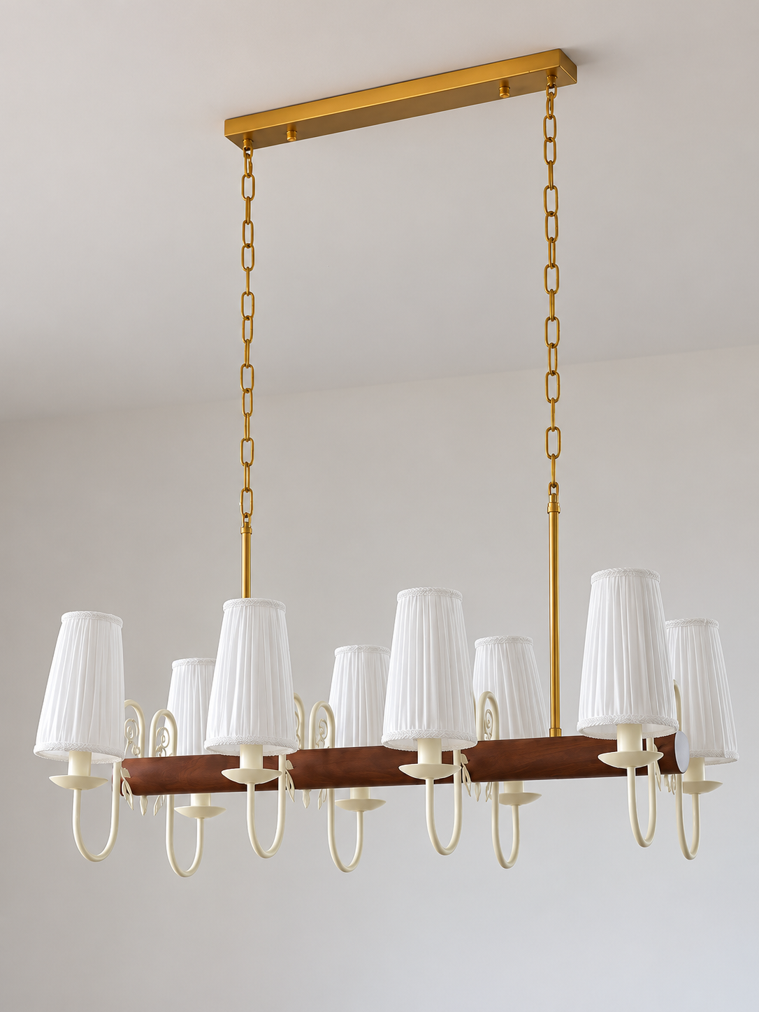 Scroll-arm chandelier with 8 white pleated fabric shades, shown unlit, product view