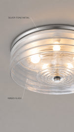 Ringed glass and silver-tone metal detail