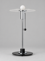 Clear glass disc table lamp with milky-white bulb finish and chrome-tone fittings, shown unlit