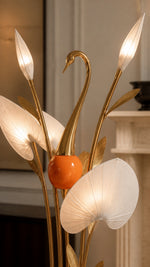 Copper-tone metal, orange painted body, and fabric shade detail