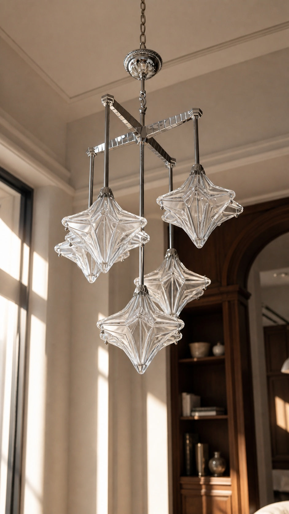 Unlit clear faceted glass shades on the suspended chandelier