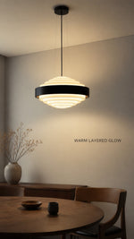 Noir Step Pendant warm layered glow in a Nordic-Bauhaus dining interior