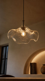 Warm light through the underside of the glass pendant