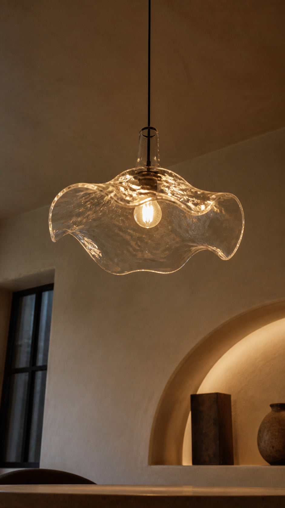 Warm light through the underside of the glass pendant