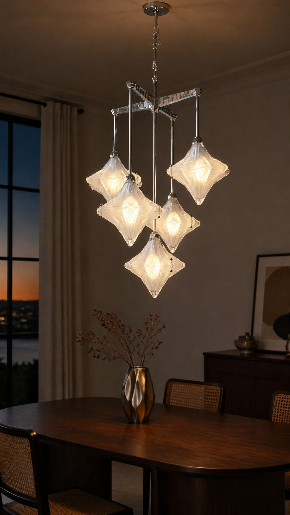 Stella Fold chandelier glowing above a dining table