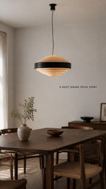 Noir Step Pendant over a dining table at realistic scale