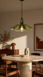 Olive glass pendant in a mid-century dining room