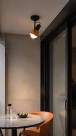 Surface-mounted spotlight at a balcony dining threshold