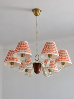 Round 6-light chandelier with red-and-white striped fabric shades, shown switched off in daylight