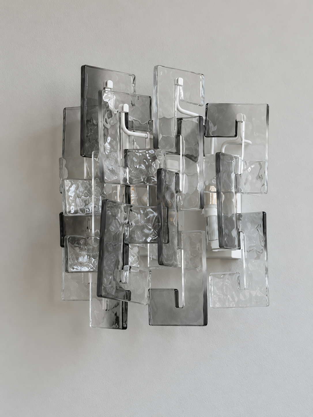 White wall sconce with smoke textured glass panels, shown switched off in daylight