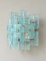 White wall sconce with blue textured glass panels, shown switched off in daylight
