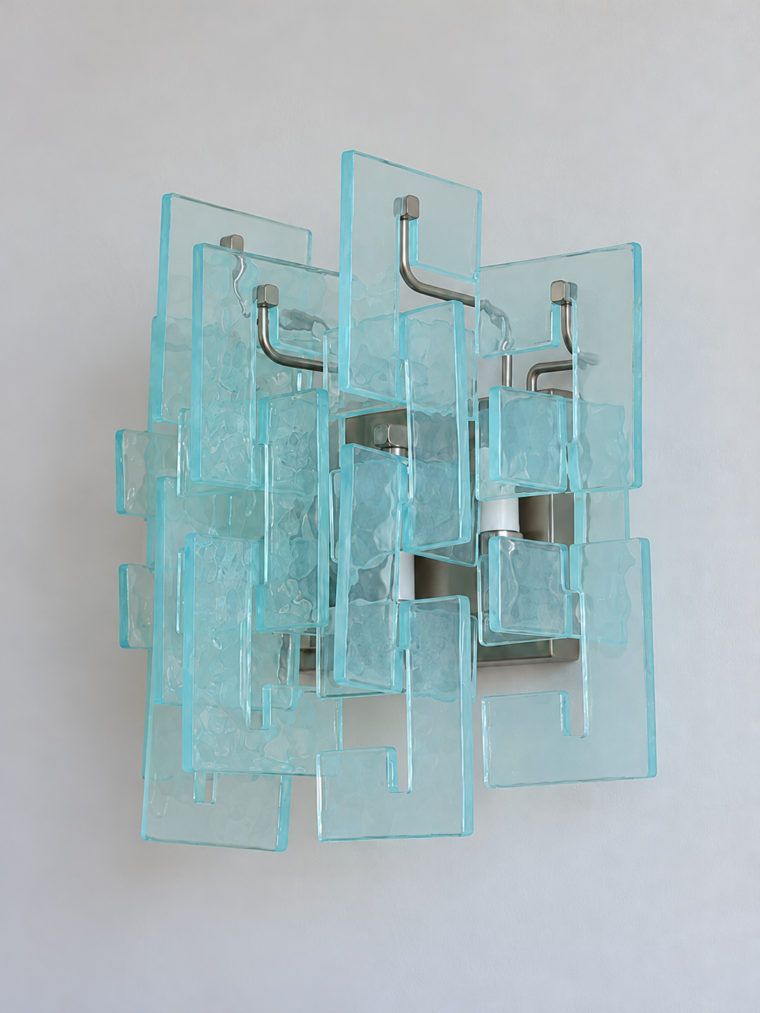 Satin Nickel wall sconce with blue textured glass panels, shown switched off in daylight