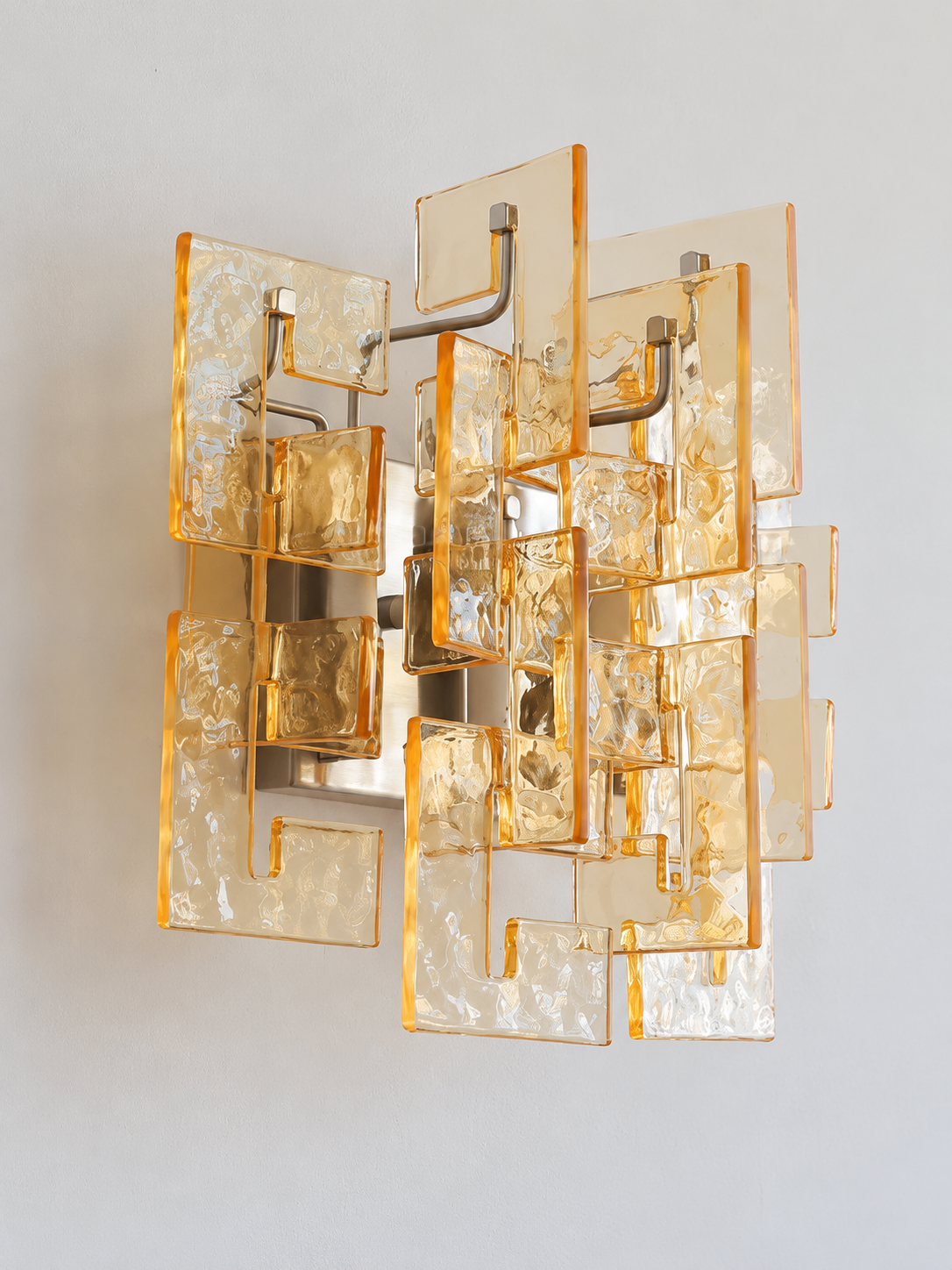 Satin Nickel wall sconce with amber textured glass panels, shown switched off in daylight