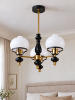 Black and copper-tone 3-light chandelier with white glass shades and ribbed finials, shown switched off