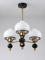 Black and copper-tone 3-light chandelier with white glass shades and faceted finials, shown switched off
