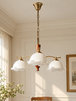 Three-light ivory bud shade chandelier, lamp off