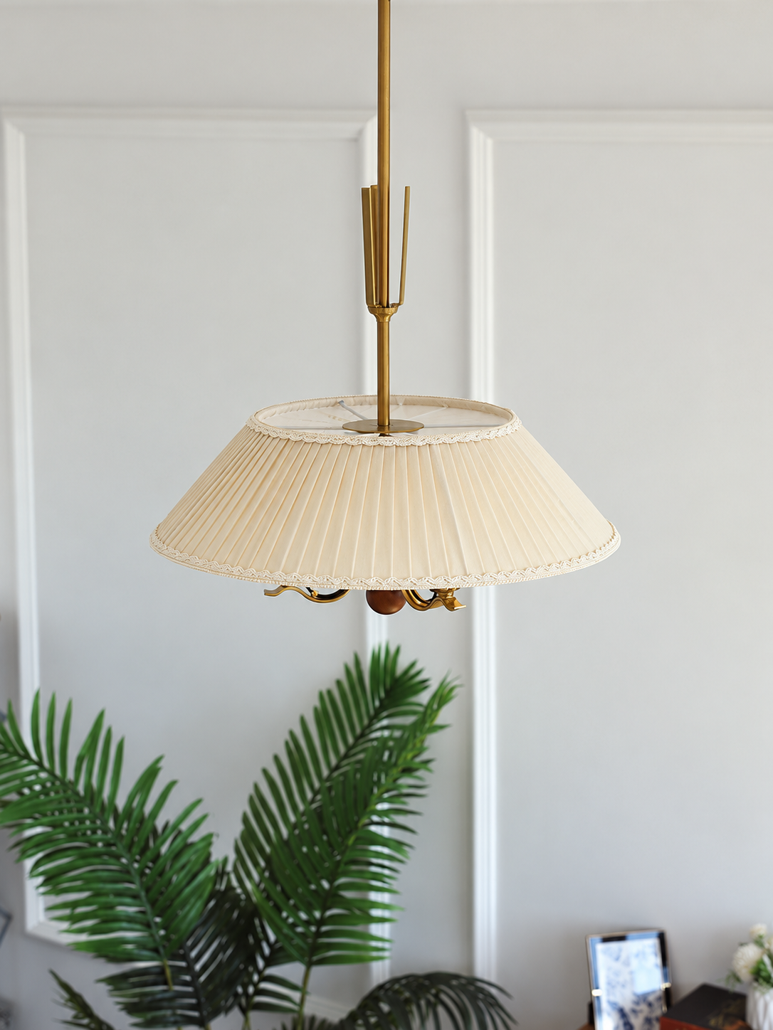 Cream pleated shade and ornamental stem, elevated detail