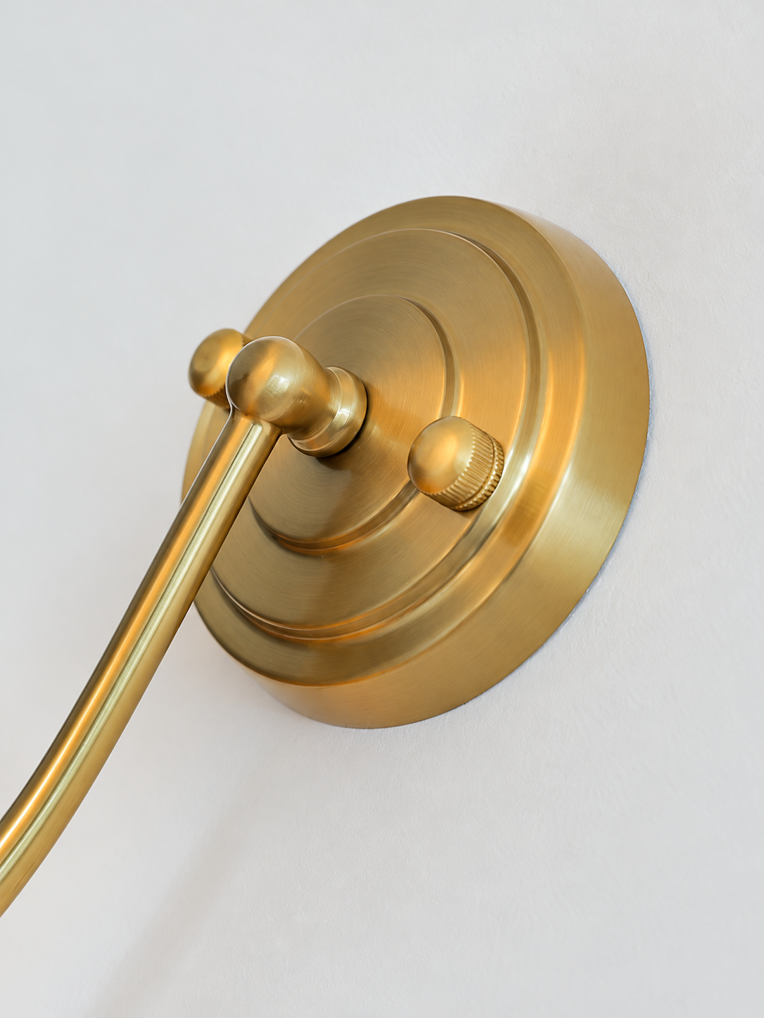 Copper-tone wall light backplate detail