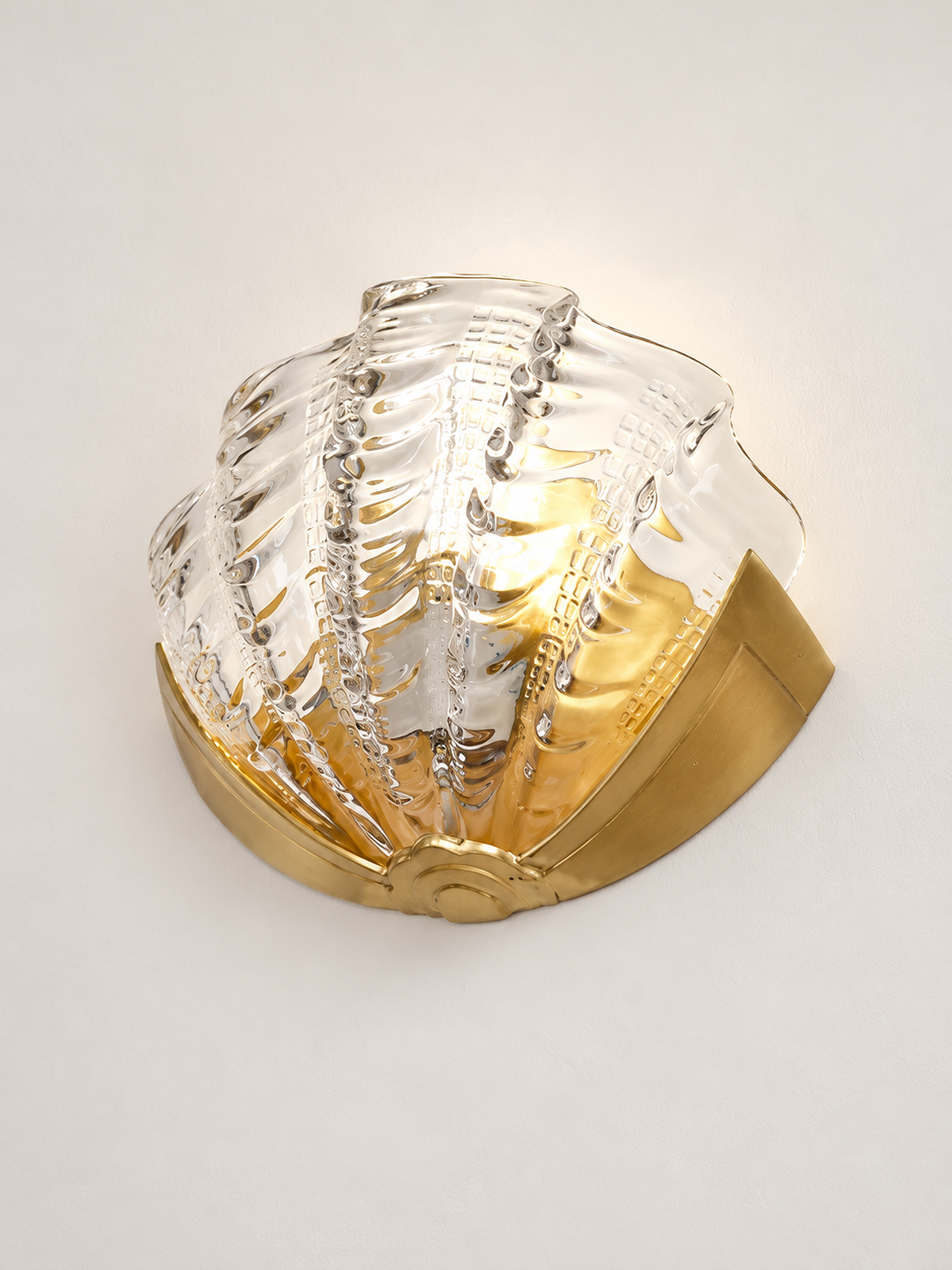 clear glass shell wall sconce with copper-tone mount