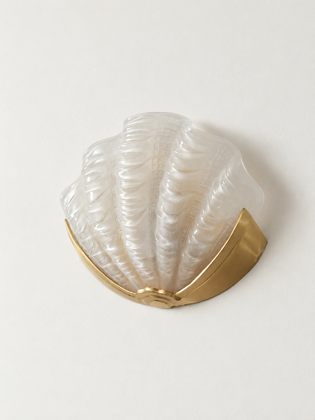 translucent glass shell wall sconce with copper-tone mount
