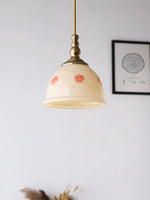 Cream-yellow floral glass pendant with copper-tone details, unlit