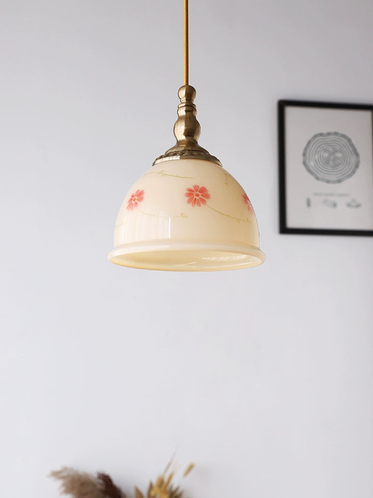 Cream-yellow floral glass pendant with copper-tone details, unlit