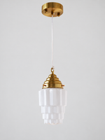 Copper-tone faceted stepped white glass pendant