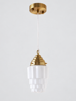Copper-tone faceted stepped white glass pendant