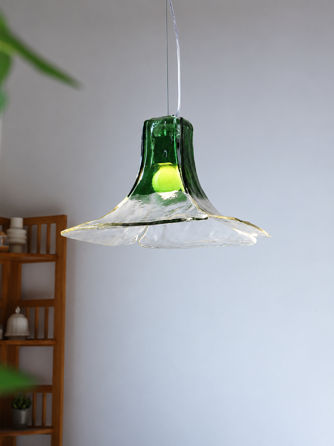 Green flared gradient glass pendant light in a room setting
