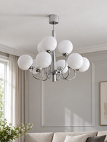 Chrome and white glass nine-light chandelier, shown switched off in a daylight living room