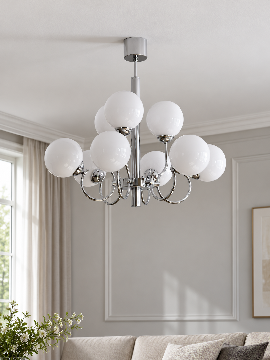 Chrome and white glass nine-light chandelier, shown switched off in a daylight living room