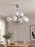 Chrome and white glass nine-light chandelier, shown switched off in a daylight dining room
