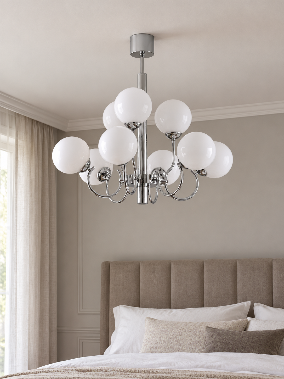 Chrome and white glass nine-light chandelier, shown switched off in a daylight bedroom