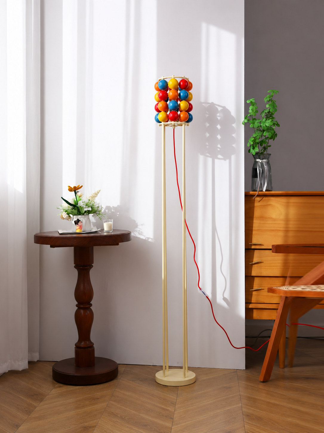 Colorful sphere floor daylight with cream metal frame and red cord