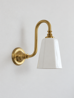 Copper-Tone bent arm wall sconce with a white ceramic shade, shown unlit