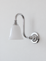 Chrome bent arm wall sconce with a white glass shade, shown unlit