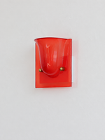 Red single head resin cup wall sconce with gold-tone fasteners, shown unlit