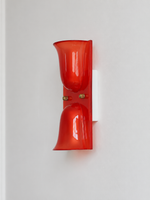Red double head resin cup wall sconce with gold-tone fasteners, shown unlit