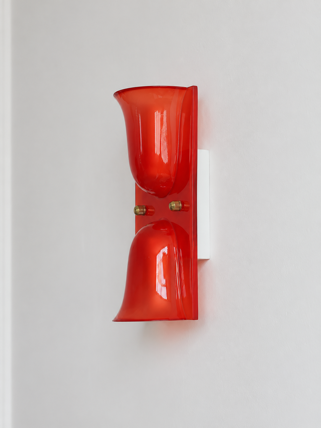 Red double head resin cup wall sconce with gold-tone fasteners, shown unlit