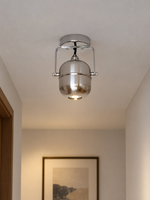 Chrome capsule ceiling spotlight, black hallway