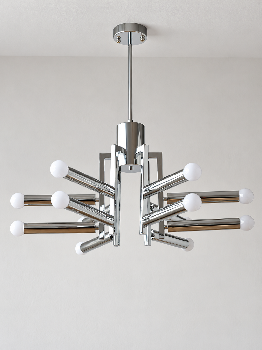 Chrome geometric12-light chandelier with milk white light sources, shown unlit in a detail composition