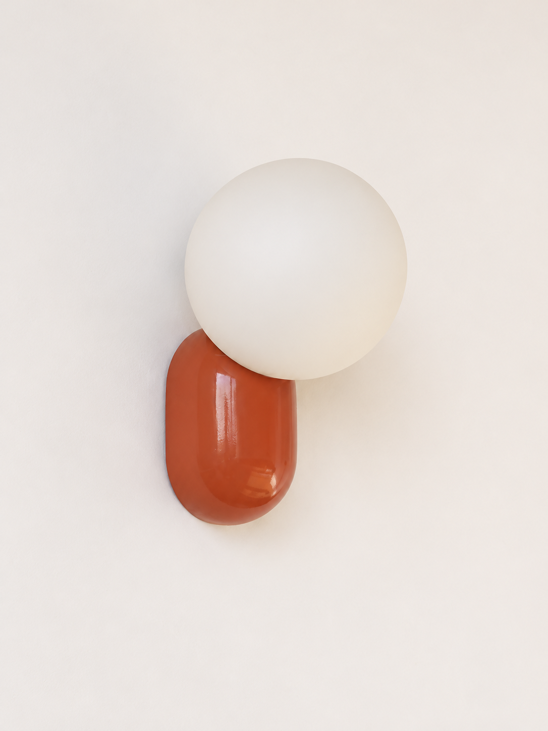 red capsule and opal globe wall light