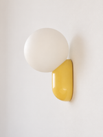 yellow capsule and opal globe wall light