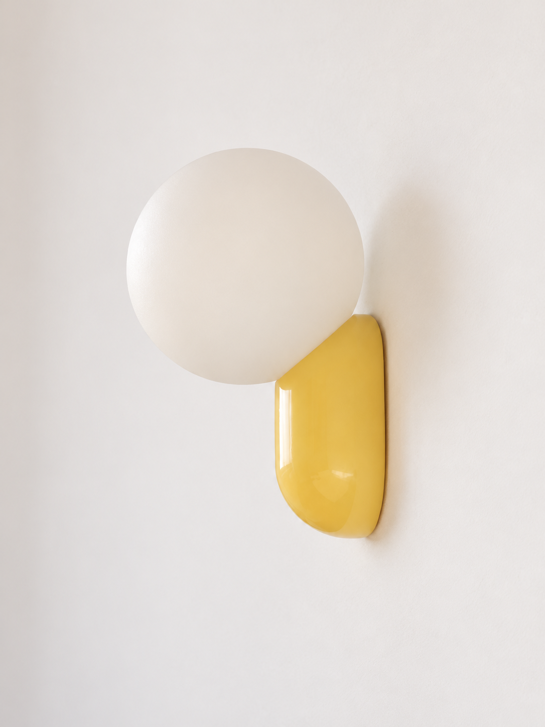 yellow capsule and opal globe wall light