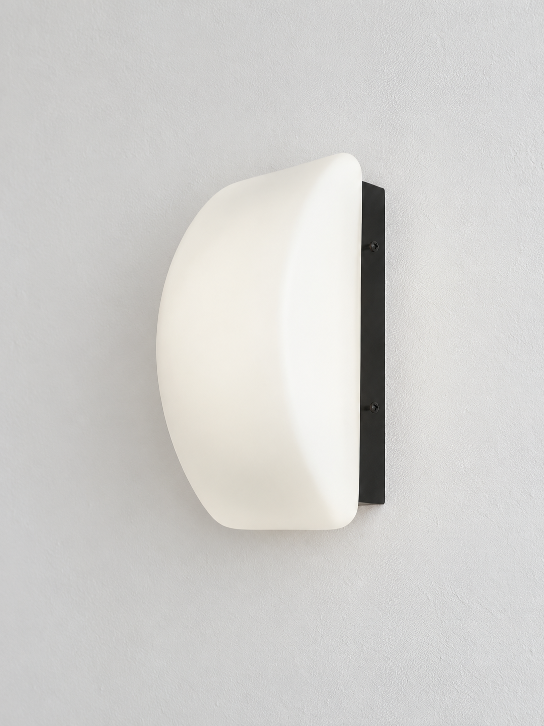 Curved white glass and black wall sconce, front view